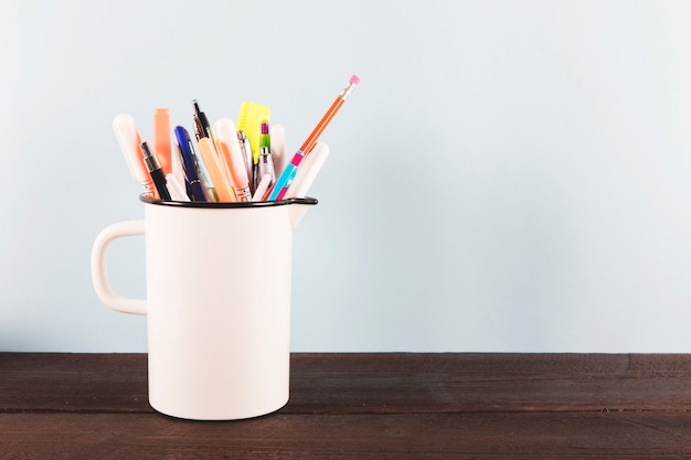 Cup with writing supplies