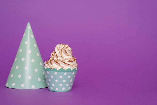 Cupcake next to paper hat