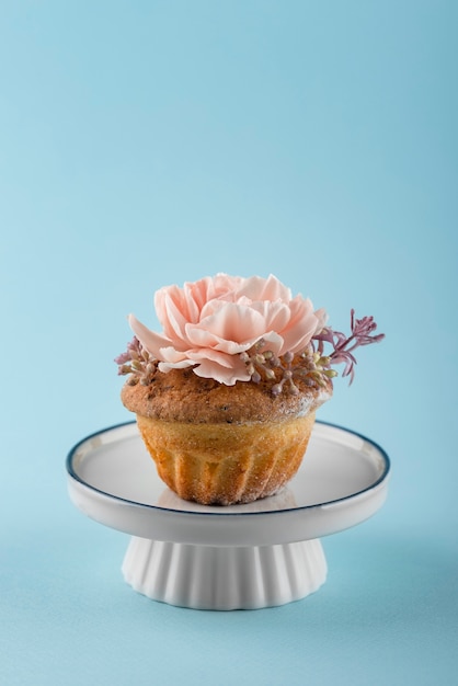 Cupcake with flower and blue background