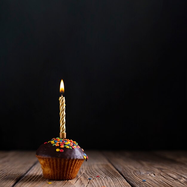 Cupcake with glaze and candle