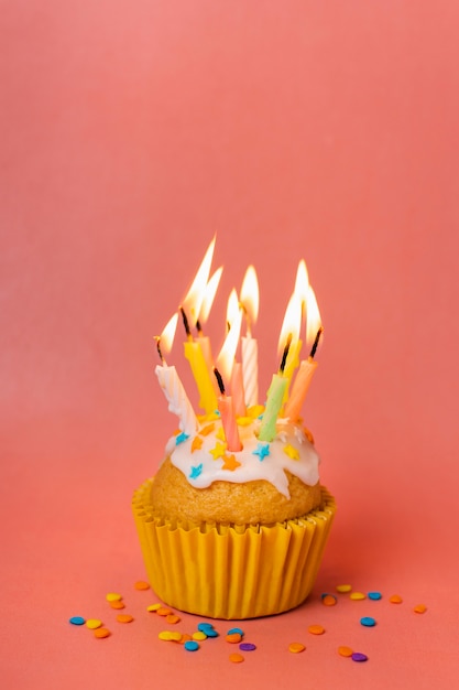 Free photo cupcake with lit candles and copy space