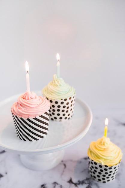 Cupcakes on display with light candles