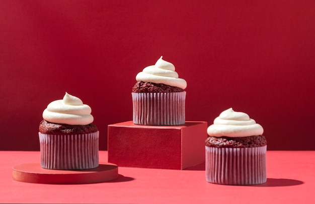 Cupcakes with cream and red background