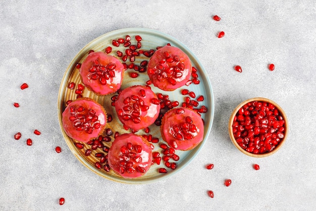 Cupcakes with pomegranate topping and seeds.