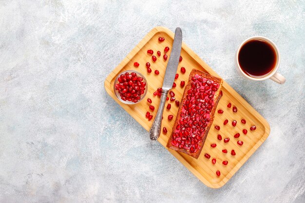 Cupcakes with pomegranate topping and seeds.