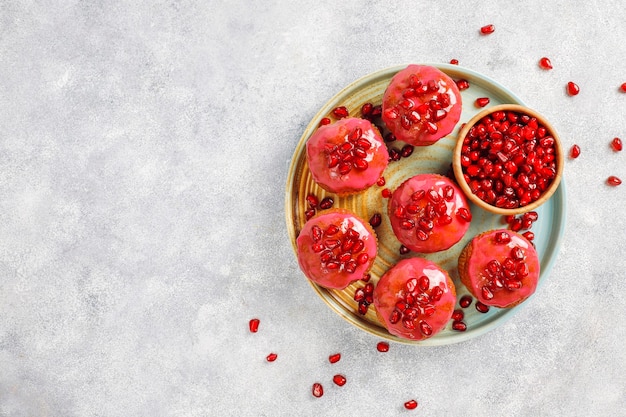 Cupcakes with pomegranate topping and seeds.