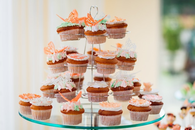 Free photo cupcakes with white cream and orange glaze