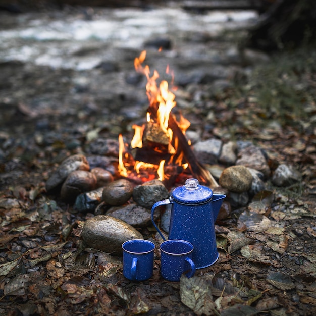 Cups and pot near fire