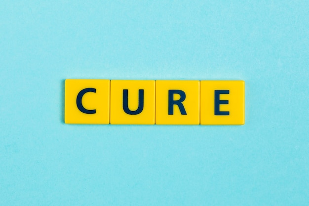 Free photo cure word on scrabble tiles