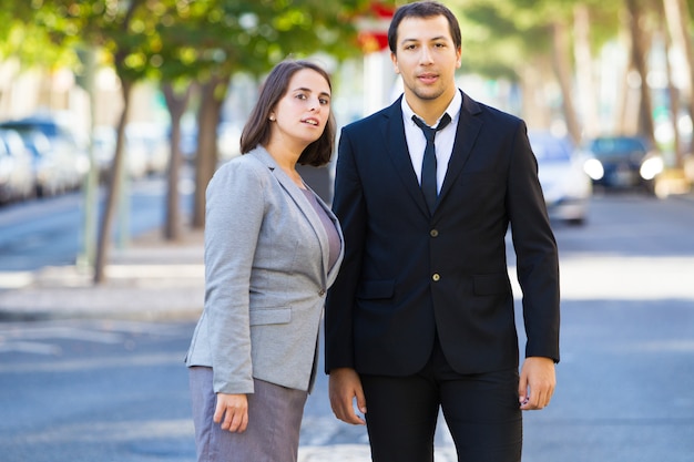 Curious business people looking with interest at camera