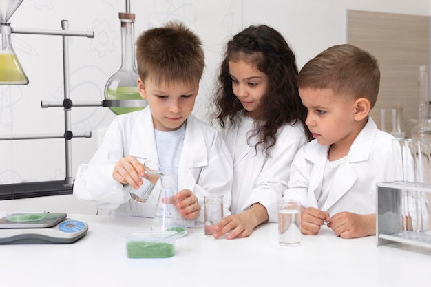 Curious children doing a chemical experiment at school