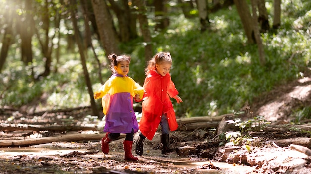 Free photo curious children participating in a treasure hunt in the forest