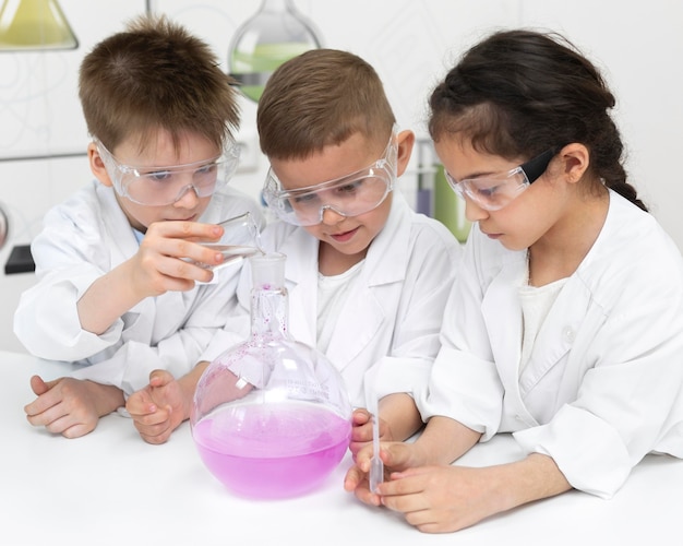 Curious kids doing a chemical experiment at school