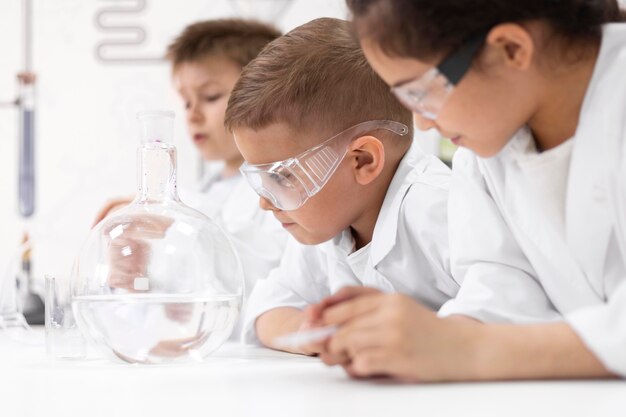 Curious kids doing a chemical experiment at school