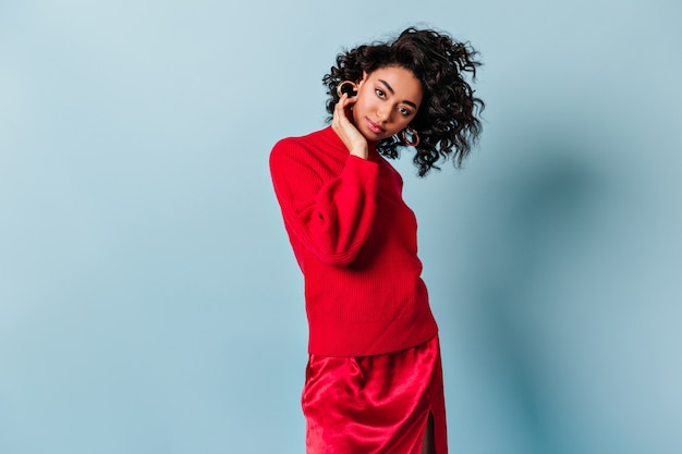 Free photo curious woman in red attire looking at front