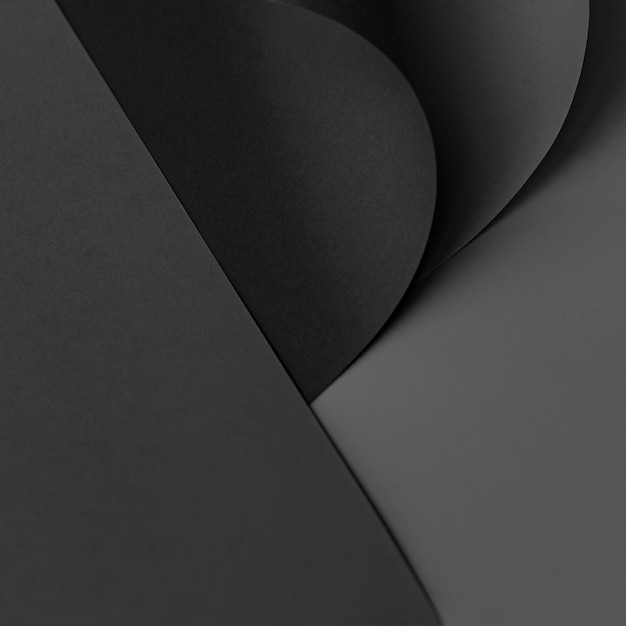 Free photo curled black chart paper on a dark gray background