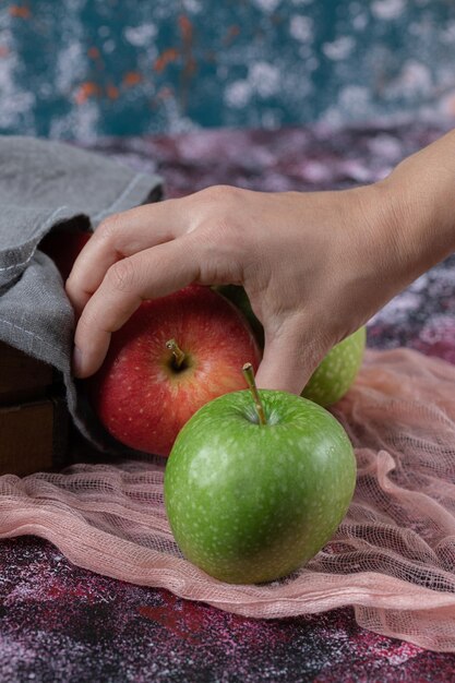 Free Photo customer holding an apple on hand.