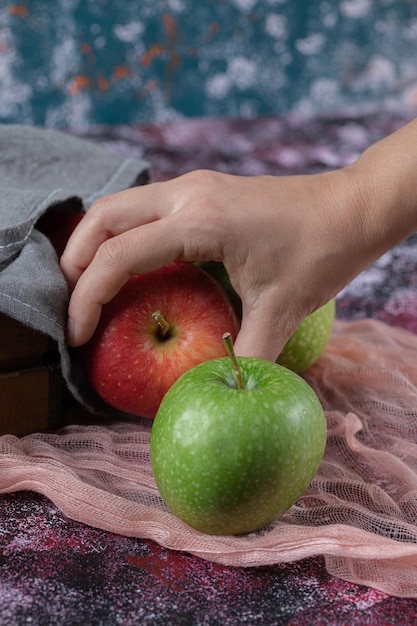 Customer holding an apple on hand.