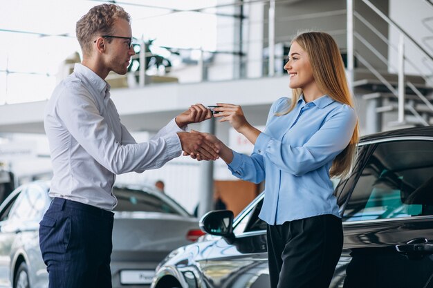 Customer making a purchase in a car showroom