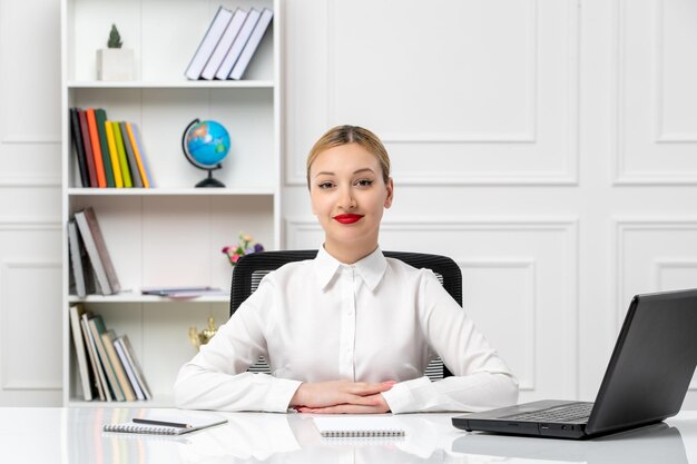 Customer service cute pretty girl in white shirt with red lipstick and laptop smiling