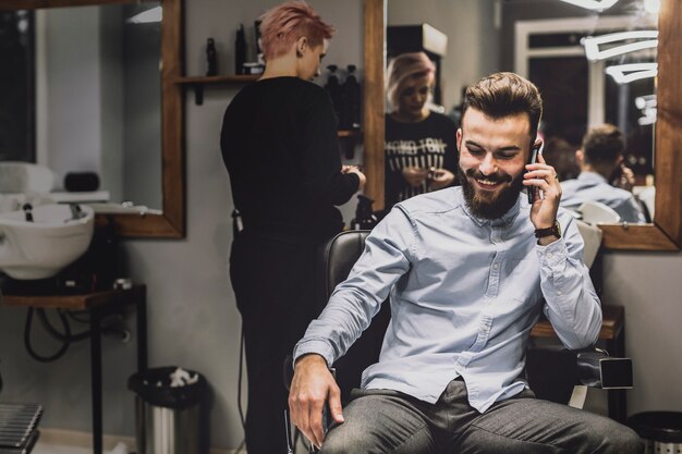 Customer talking on phone in barbershop