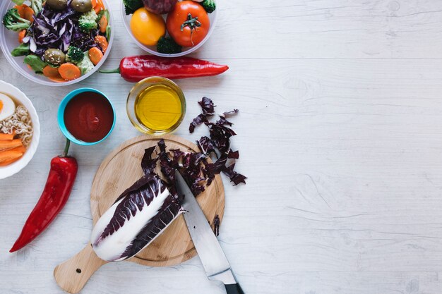 Cut cabbage near sauces and vegetables