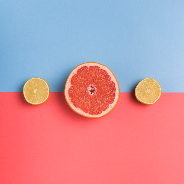 Free photo cut citrus fruit on colorful background