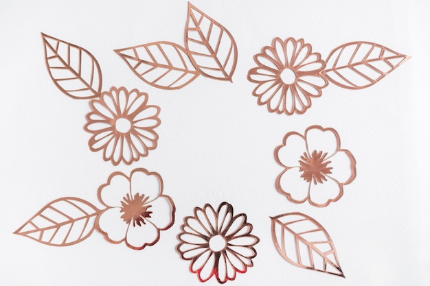 Free Photo cut out golden flowers and leaves on white background