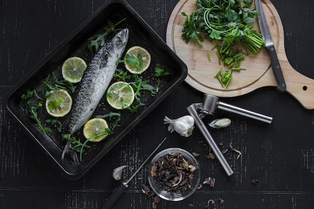 Cut parsley and spices near fish