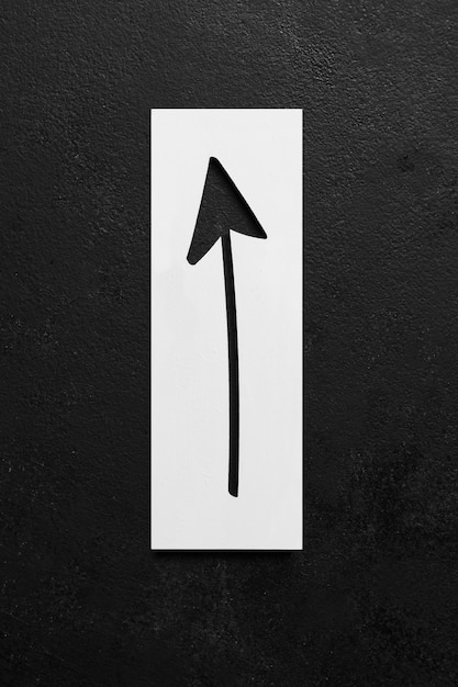 Free photo cut silhouette of arrow on black background