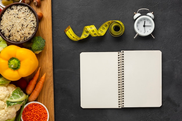 Free photo cutboard with groceries and notebook mock-up