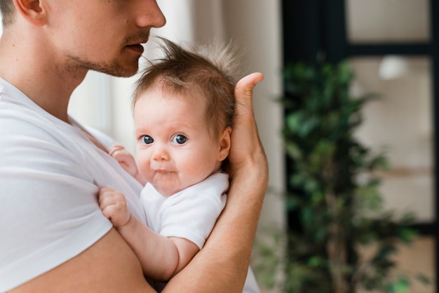 Free Photo cute baby in father hands