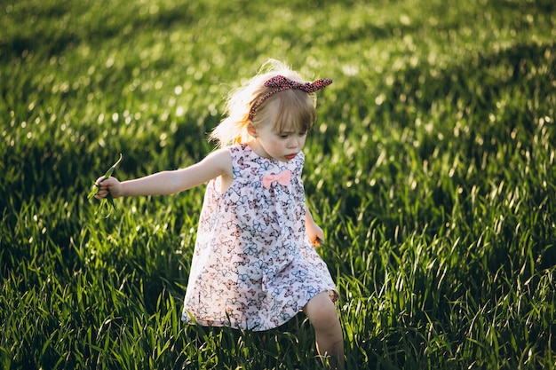 Cute baby girl in field