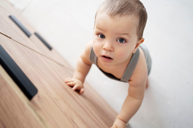 Free photo cute baby going for their first steps