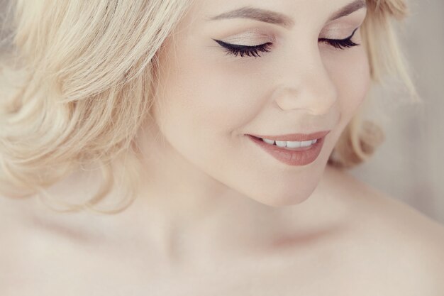 Cute beautiful blonde woman portrait, eyes closed