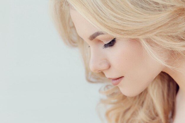 Cute beautiful blonde woman portrait, side profile view