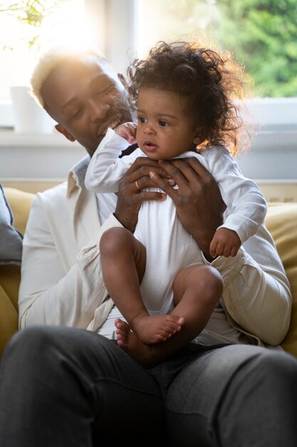 Cute black baby at home with parents