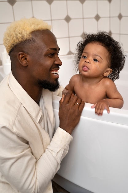 Cute black baby at home with parents