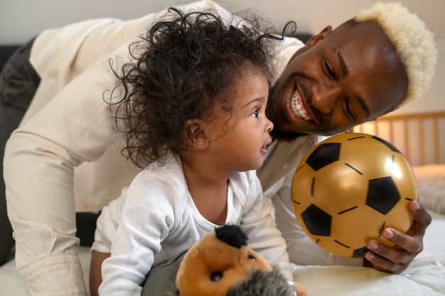 Cute black baby at home with parents