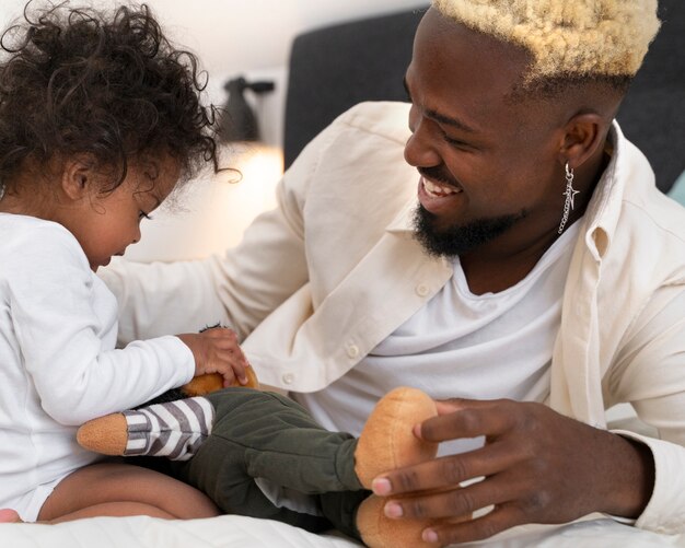 Cute black baby at home with parents