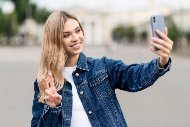 Free Photo cute blonde girl taking a selfie