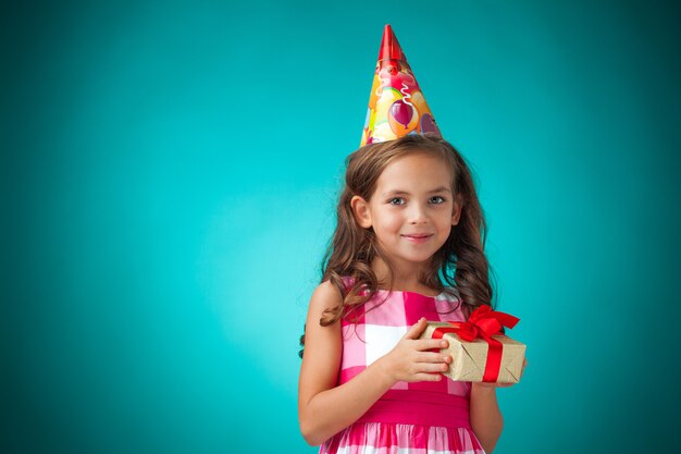 cute cheerful little girl on blue