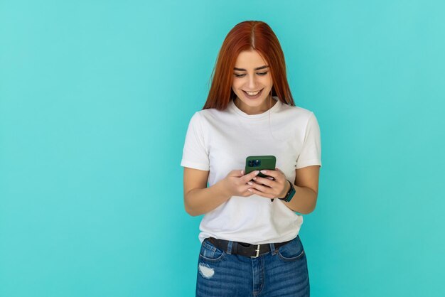 Cute cheerful woman use her smartphone read news wear grey knitted sweater isolated on teal turquoise