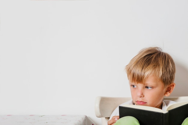 Cute child sitting with book