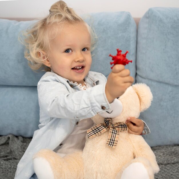 Cute child with toy at home during quarantine