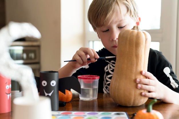 Free photo cute children with pumpkins halloween concept