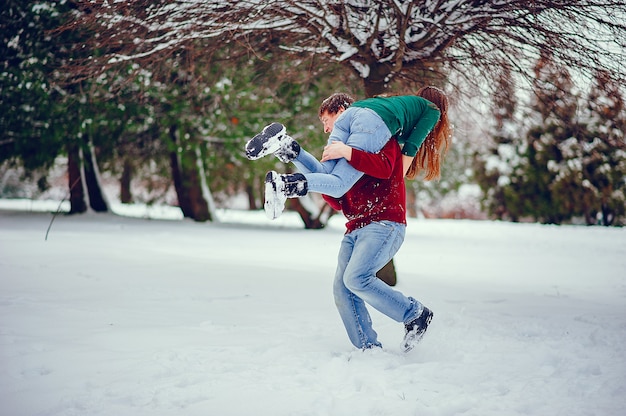 Cute couple have fun in a winter park