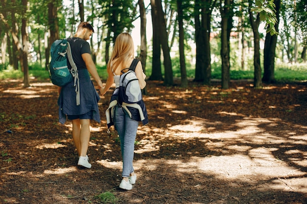 Free photo cute couple have a rest in a summer forest