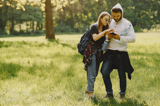 Cute couple have a rest in a summer forest