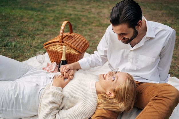 Cute couple having a picnic together outdoors